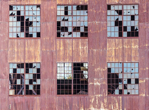 Urban abandoned industrial building with broken windows background