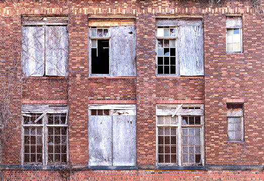 Urban abandoned industrial building with broken windows background