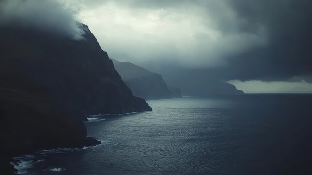 Dark storm clouds gather over the dramatic ocean coast showcasing moody atmospheric lighting.