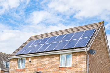 Photovoltaic panels mounted on the roof of a modern home as part of a renewable energy system © Tatjana