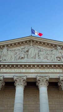 Palais Bourbon in Paris, seat of the Assembl&eacute;e Nationale, neoclassical facade with grand columns and pediment under a clear blue sky, symbolizing French government and law