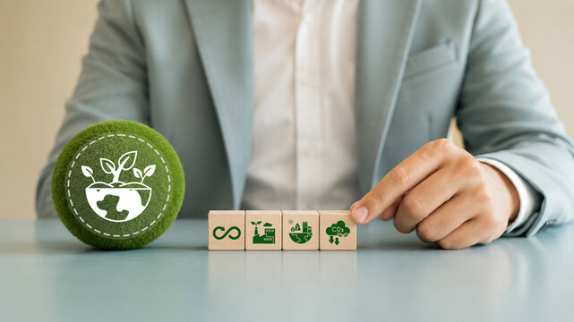 Corporate Sustainability Strategy concept. A green globe icon and wooden blocks displaying symbols for circular economy, green industry, environmental preservation and carbon reduction