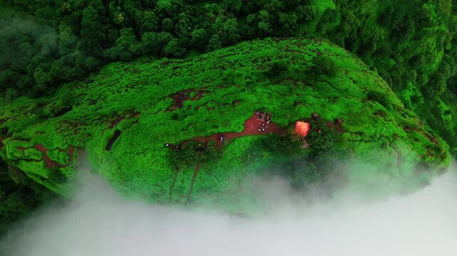 Monsoon Clouds Engulfing Green Cliff  4K Aerial Shot
