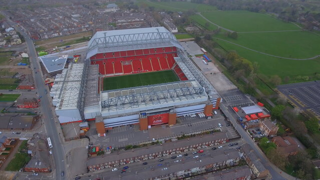 4K aerial drone view of Anfield Stadium in Liverpool, England. High-angle shot featuring the iconic Liverpool FC football ground and cityscape.