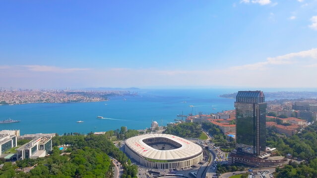 4K aerial drone view of Istanbul, Turkey. Panoramic cityscape featuring Beşiktaş Stadium, The Ritz-Carlton, Dolmabah&ccedil;e Mosque, and the Bosphorus.