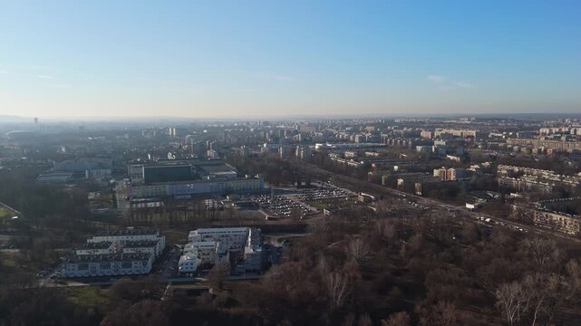 In Nowa Huta, Krak&oacute;w, mid-rise residential blocks form a dense urban landscape around streets and green spaces, captured in an aerial view that highlights its postwar architectural layout.