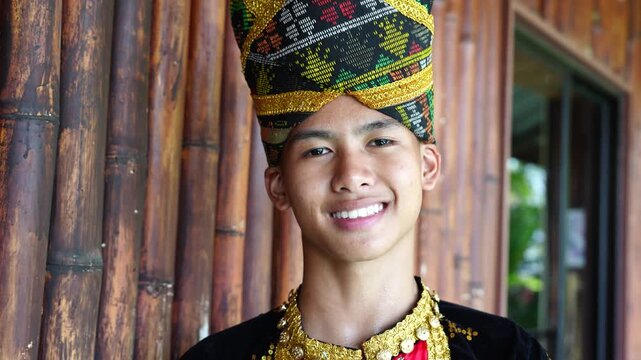 Portrait of young man in complete set of Dusun Tindal clothes Sinipak during Harvest Festival in Sabah
