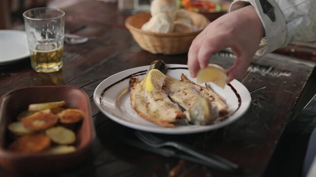 Close-up of traditional Argentine goat meat served on a rustic dining table with blurred background.