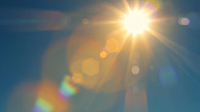 Brilliant sunburst with lens flare and bokeh effects against a clear blue sky symbolizing bright ideas and optimism perfect for concepts of innovation 4k Video