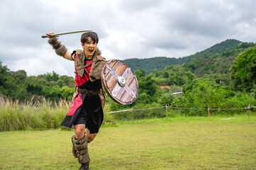 Obraz premium Male ancient warrior in full armor holding sword and shield, ready for battle