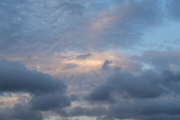 Obraz premium Dark blue and gray clouds at sunset. 