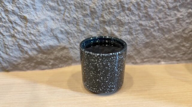 Steaming hot ocha green tea in ceramic cup, traditional Japanese tea experience. BSD, Indonesia - January 5, 2025
