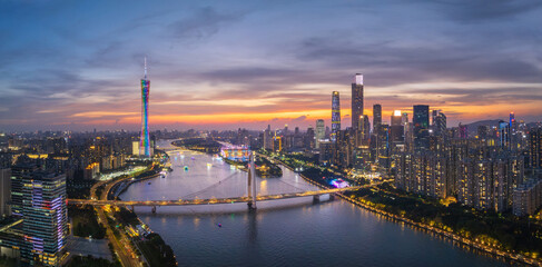 Fototapeta premium Aerial View of Guangzhou Skyline at Dusk with River and City Lights