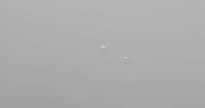 Water droplets on a white surface. Can be used as background for design projects. 