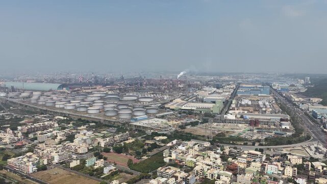 Aerial view of oil refinery and storage tanks polluting the air