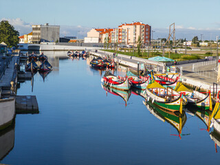 Traditional moliceiro boats docked along the central canal in Aveiro, Portugal
