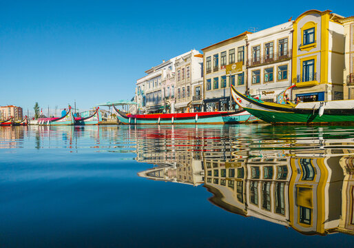 Traditional moliceiro boats docked along the central canal in Aveiro, Portugal
