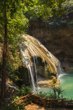 The beautiful turquoise waterfall is located in Ko Kluang National Park, Li District, Lamphun Province, in northern Thailand. Vertical photo