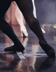Ballet dancers couple during performance repetition, classic ballet rehearsal practicing in ballroom, view of legs in pointe shoes, ballerina and ballet dancer on a concert hall theatre stage floor © tsuguliev