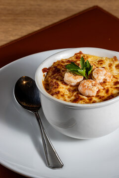Baked Brazilian Shrimp Chiclete in a Ceramic Bowl with Golden Browned Cheese Crust