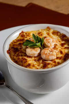 Baked Brazilian Shrimp Chiclete in a Ceramic Bowl with Golden Browned Cheese Crust