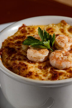 Baked Brazilian Shrimp Chiclete in a Ceramic Bowl with Golden Browned Cheese Crust