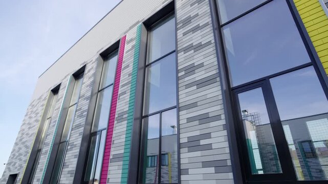 Contemporary school building facade decorated with tile pattern low angle shot. Modern urban architectural style of education facility