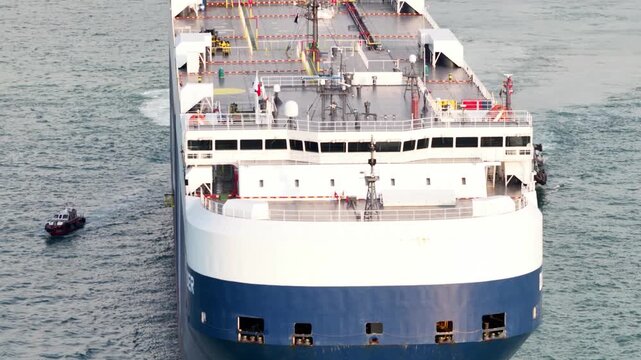 Huge car carrier ship arriving at commercial port