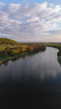 Aerial flyover over a river in Poland at sunset in spring