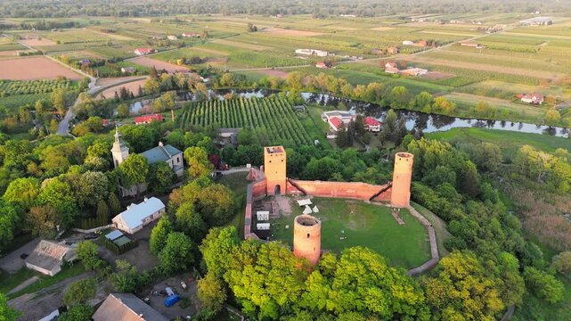 Aerial flyover of castle ruins in Poland at sunset in spring