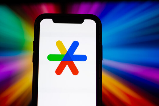 Google Assistant application displayed on smartphone screen with colorful digital background, mobile AI and voice technology concept