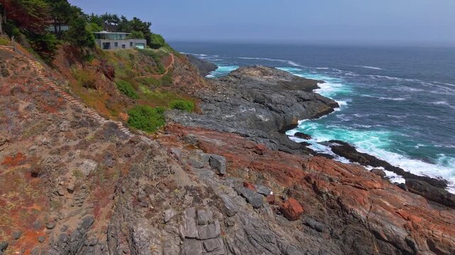 Aerial view dolly in granite rock formations along Chile's central coast in Pite, luxury mansions atop rocky mountains