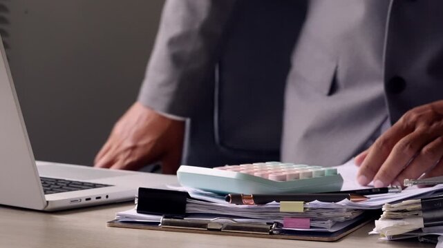 Creative Designer Working at Desk with Laptop and Design Materials