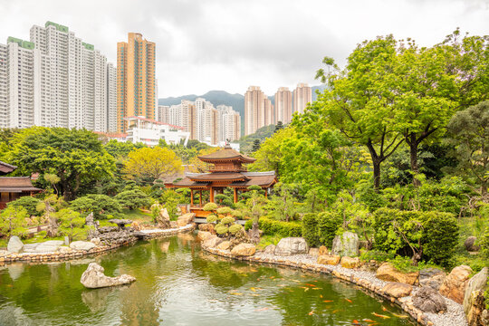Ancient Wooden Pavilion on a Pond and Hong Kongs Skyscrapers