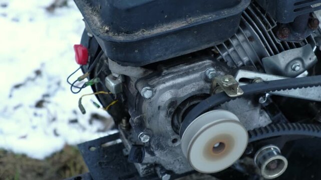 Engine of the motor cultivator is running. Close-up of motor components in operation, automotive mechanics, maintenance and inspection, vehicle power system and performance in real conditions. Closeup