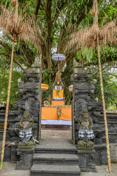 Indonesian statue in a temple with offerings