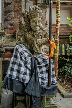 Indonesian statue in a temple with offerings