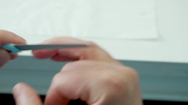 Close up manicure routine with nail filing and personal grooming