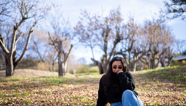 Woman relaxing in park enjoying autumn nature