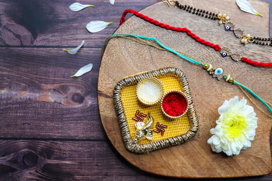 Indian festival Raksha bandhan. Rakhi thali with diya, flowers and tilak with sweet boondi or bundi. Puja thali for rakhi festival with roli chawal. copy space. also known as Narali Purnima. 