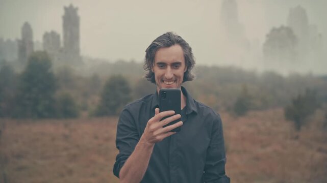 Post-apocalyptic abandoned city &mdash; man lost in fog checks smartphone and smiles, connection and civilization gone