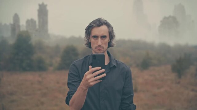 Man checking smartphone in foggy abandoned city, post‑apocalyptic mood, lost connection and collapse of civilization