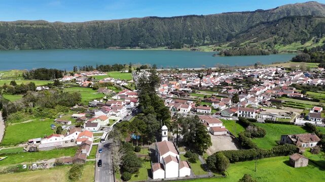 aerial view of Azores, Sao Miguel Island, Vila Franca do Campo, Lagoa das Sete Cidades , Drone above village with church and white traditional houses