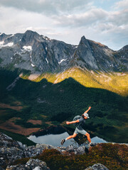 Man athlete trail running solo at the mountain cliff above lake in Norway travel hiking adventure outdoors active traveler enjoying healthy lifestyle on summer vacations endurance freedom concept © EVERST