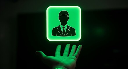 Fototapeta premium Hand holding glowing green businessman icon in dark professional setting