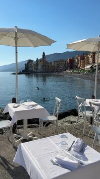 Enjoying lunch at a cafe by the sea in Camogli, Italy on a sunny day
