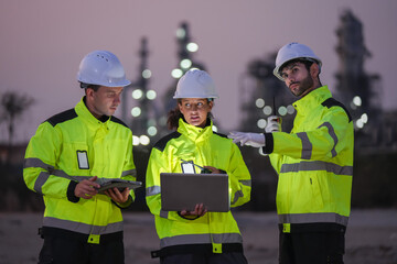 Fototapeta premium Collaborative safety briefing among engineers at industrial site nighttime professional meeting urban environment close-up teamwork