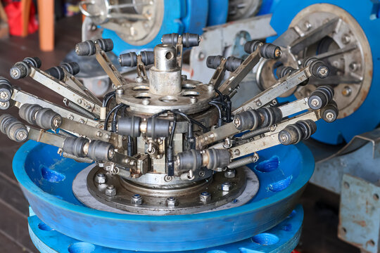 Industrial smart pigging inspection tool with mechanical caliper sensor arms and rollers on a blue polyurethane cup base.