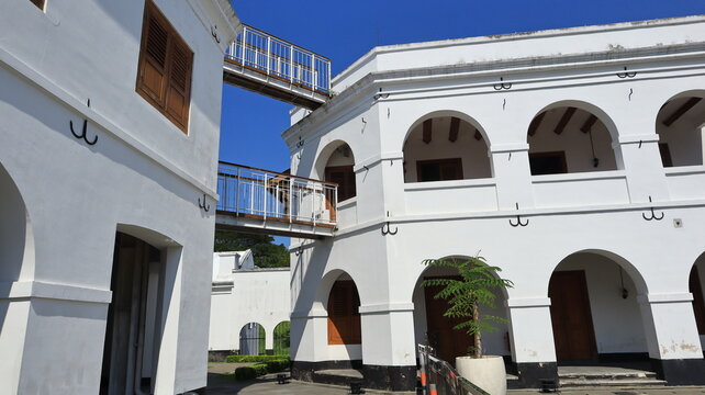 Large arched windows adorn the white building.