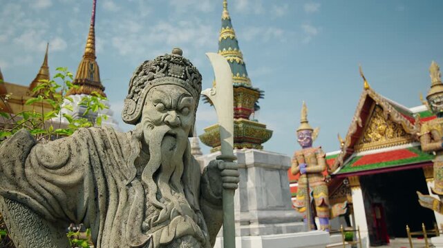 Stone guardian warrior statue at Wat Phra Kaew in Bangkok, traditional Thai temple architecture and mythology landmark